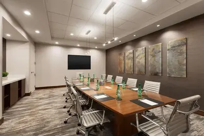 a conference room with a long table and chairs at DoubleTree by Hilton Bradley International Airport in Windsor Locks