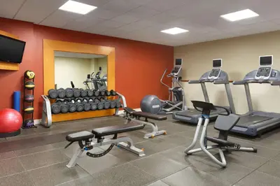 a gym with several treadmills and exercise machines at DoubleTree by Hilton Bradley International Airport in Windsor Locks