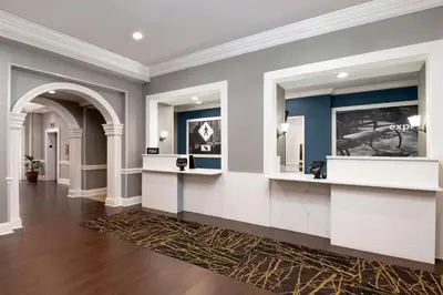 a room with a hallway with blue walls and mirrors at Hampton Inn & Suites Stamford in Stamford