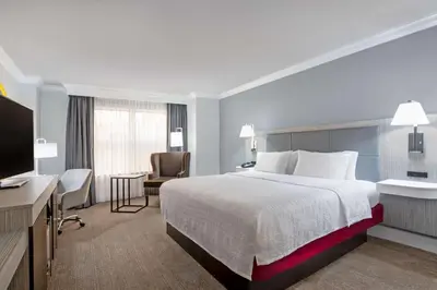 a hotel room with a bed and a desk and a television at Hampton Inn & Suites Stamford in Stamford