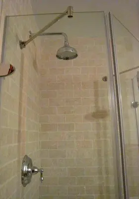 a shower with a glass door with a shower head at The Catskill Cabin in Elka Park