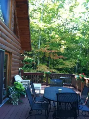 a patio with a table and chairs on a porch at The Catskill Cabin in Elka Park