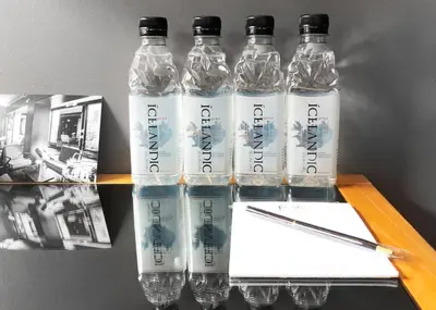 three bottles of water sitting on a table with a pen at Hotel Henri NY in New York