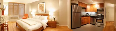 a small bedroom with a bed and a kitchen at Sanctuary NYC Retreats in New York