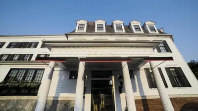 a white building with a clock tower on top at Delamar Southport in Southport