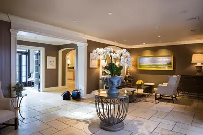 a living room with a vase of flowers on a table at Delamar Southport in Southport