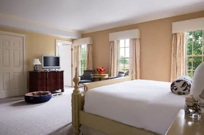 a bedroom with a large bed and a television at Delamar Southport in Southport