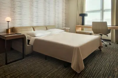 a hotel room with a large bed and a desk at Residence Inn by Marriott Norwalk in Norwalk