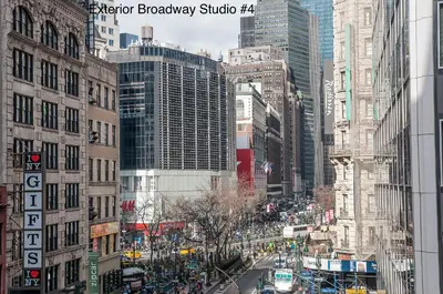 a view of a busy city street with tall buildings at NYC Empire Apartments in New York