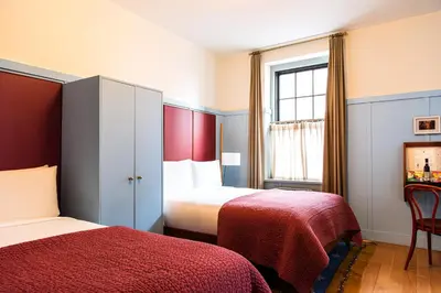 a hotel room with two beds and a window at Hotel Kinsley, a Member of Design Hotels in Kingston