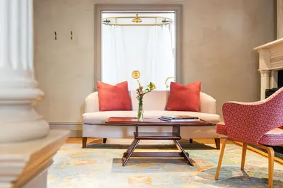 a living room with a couch and a table at Hotel Kinsley, a Member of Design Hotels in Kingston