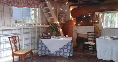 a room with two tables and chairs and a fireplace at The Gables of Rhinebeck in Rhinebeck