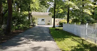 a house with a white fence and a driveway at The Gables of Rhinebeck in Rhinebeck