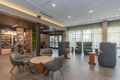 a waiting room with chairs and a table at Courtyard by Marriott West Springfield in West Springfield