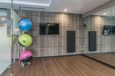 a bowling alley with two balloons and a tv at Courtyard by Marriott West Springfield in West Springfield