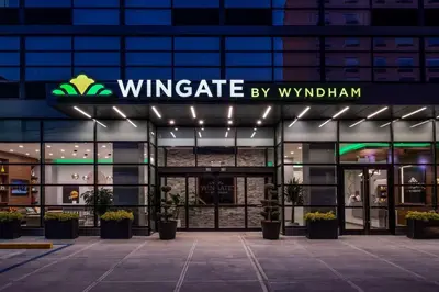 a building with a sign that reads wingate by windham at Wingate by Wyndham Long Island City in Queens