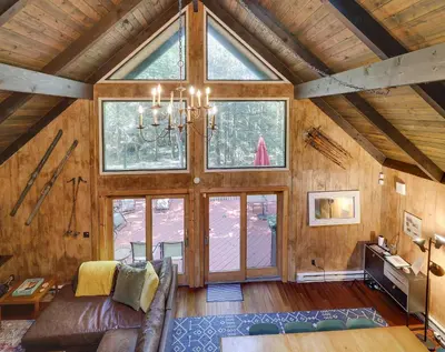 a living room with a couch and a large window at ⛰⛵️⛱Mt. Maplewood Lodge❤️Seasonal Specials ☆Poconos☆Cabin☆Hot⛷Tub☆Game Room☆ in Pocono Pines