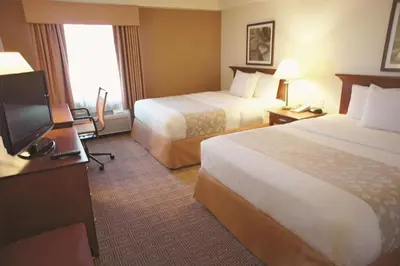 a hotel room with two beds and a flat screen tv at La Quinta by Wyndham Stamford / New York City in Stamford