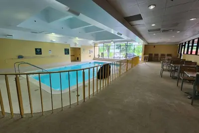 a swimming pool with a ramp in a building at La Quinta by Wyndham Stamford / New York City in Stamford