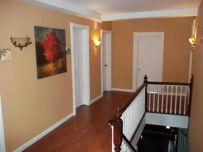 a room with a staircase and a painting on the wall at Tin Brook Bed & Breakfast in Walden