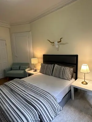 a bedroom with a bed with a bird on the wall at TIME SQUARE 42nd Street Private Room in New York
