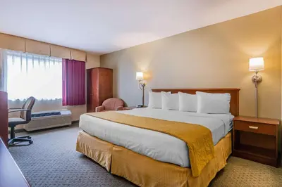 a hotel room with a large bed and a window at Quality Inn Hyde Park - Poughkeepsie North in Hyde Park