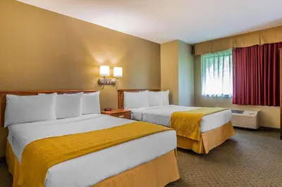 a hotel room with two beds and a window at Quality Inn Hyde Park - Poughkeepsie North in Hyde Park