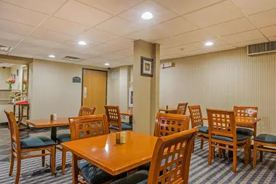 a dining room with wooden tables and chairs at Quality Inn Hyde Park - Poughkeepsie North in Hyde Park