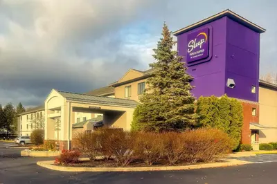 a large purple building with a sign on it at Sleep Inn & Suites Queensbury - Lake George in Queensbury