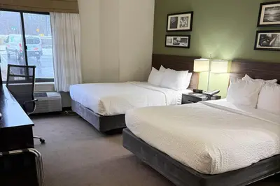 a hotel room with two beds and a window at Sleep Inn & Suites Queensbury - Lake George in Queensbury