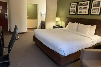 a bedroom with a large bed in a hotel room at Sleep Inn & Suites Queensbury - Lake George in Queensbury