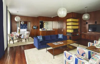 a living room with a blue couch and a table at The Maritime Hotel in New York