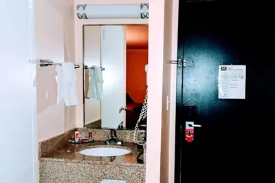 a bathroom with a sink and a mirror at Econo Lodge Milldale - Southington in Plantsville