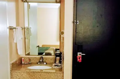 a bathroom with a sink and a mirror at Econo Lodge Milldale - Southington in Plantsville