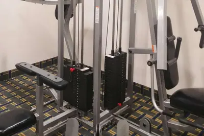 a gym with two treadmills and some weights at Econo Lodge Milldale - Southington in Plantsville