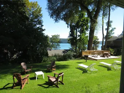 a group of chairs and benches in the grass at Hickory Grove Motor Inn - Cooperstown in Cooperstown