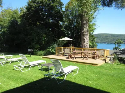 a group of chairs and a table and a bench at Hickory Grove Motor Inn - Cooperstown in Cooperstown