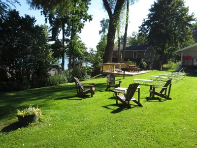 a group of park benches sitting in the grass at Hickory Grove Motor Inn - Cooperstown in Cooperstown
