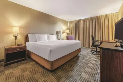 a hotel room with a bed and a television at Ramada Inn by Wyndham Fairfield NJ in Fairfield