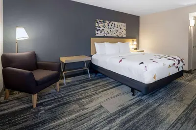 a hotel room with a bed and a chair at Baymont by Wyndham White Plains - Elmsford in Elmsford