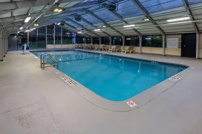 a large swimming pool in a building at Baymont by Wyndham White Plains - Elmsford in Elmsford