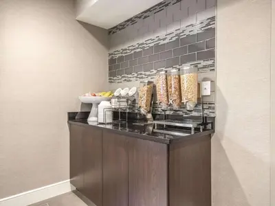 a kitchen with a counter with food on it at La Quinta by Wyndham Hartford Bradley Airport in Windsor Locks
