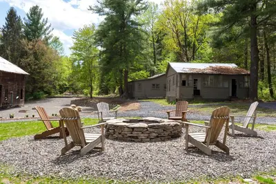 a group of chairs sitting around a fire pit at Stonehill's Farmhouse in Accord