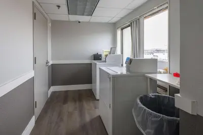 an office with a desk with two computers and a window at La Quinta by Wyndham New Haven in New Haven
