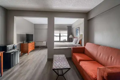 a living room with a couch and a bed at La Quinta by Wyndham New Haven in New Haven