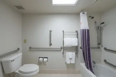 a bathroom with a toilet and a shower at La Quinta by Wyndham New Haven in New Haven