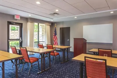 a classroom with tables and chairs and a whiteboard at Courtyard by Marriott Oneonta in Oneonta