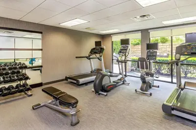 a gym with treadmills and elliptical machines at Courtyard by Marriott Oneonta in Oneonta