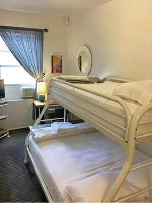 a bedroom with two bunk beds and a mirror at American Dream in New York