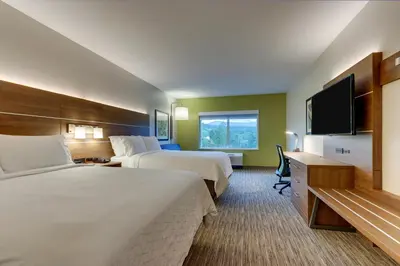 a hotel room with two beds and a flat screen tv at Holiday Inn Express & Suites - Saugerties - Hudson Valley by IHG in Saugerties